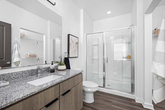 A modern bathroom with a walk-in shower and double sinks.