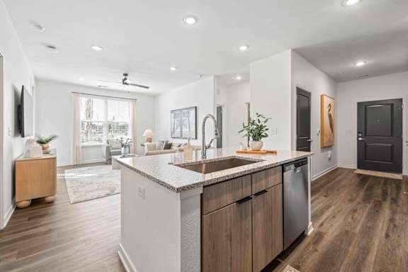 A modern kitchen with wooden cabinets and a large island at Verity Luxury Apartments, Vero Beach, FL