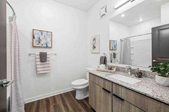 A bathroom with a white toilet and a sink at Verity Luxury Apartments, Vero Beach, Florida