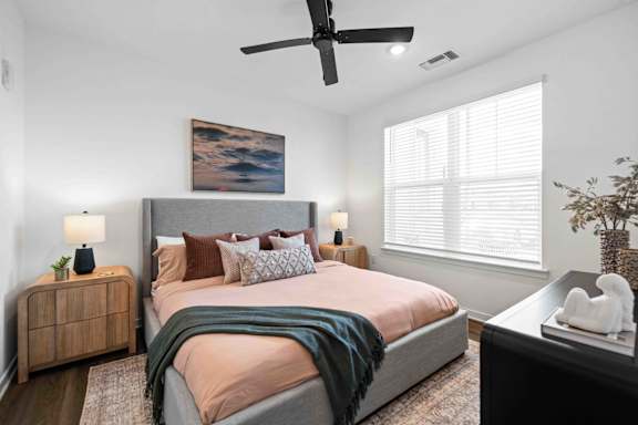 A bedroom with a large bed and a ceiling fan at Verity Luxury Apartments, Vero Beach, FL 32960
