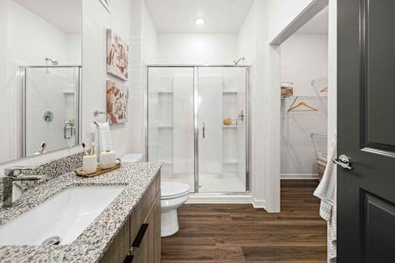 A bathroom with a white sink and a walk-in shower at Verity Luxury Apartments, Vero Beach, 32960