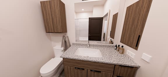 A bathroom with a toilet, sink, and mirror at Verity Luxury Apartment Homes Apartments, FL, 32960