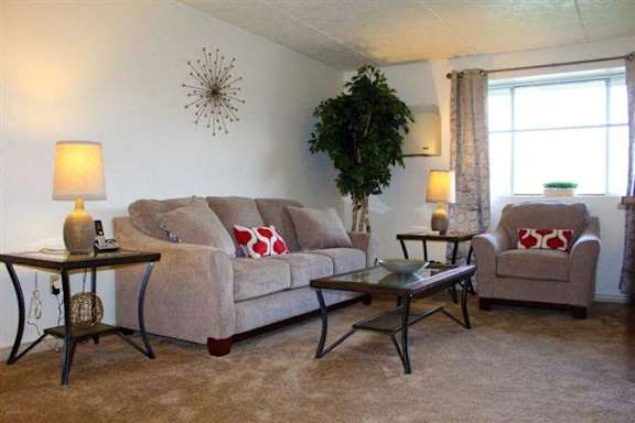 A living room with a couch, chair, and coffee table.
