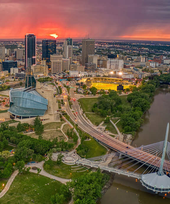 A cityscape with a prominent bridge and a large building with a dome-like structure.