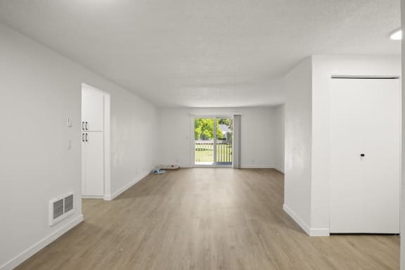 a bedroom with hardwood floors and white walls at Chalet, Springfield, Oregon