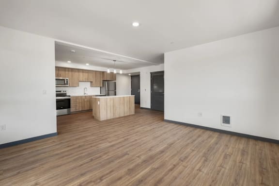 A kitchen area with wooden floors and white walls at Elevation16 Apartments, Seattle, WA, 98146