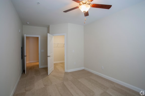 a bedroom with a ceiling fan at The Retreat at Sixty-Eight Apartments, Greensboro, NC, 27409