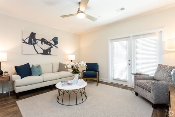 a living room with white walls and a ceiling fan at Fuquay-Varina Apartments, Fuquay-Varina