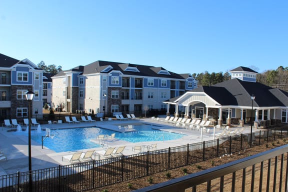 a large swimming pool with lounge chairs and a building in the background  at The Retreat at Sumter, Sumter, 29150