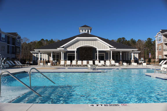 a large pool with a building in the background at Fuquay-Varina Apartments, North Carolina, 27526