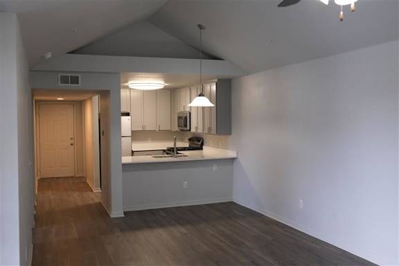 A kitchen with a counter and a sink.