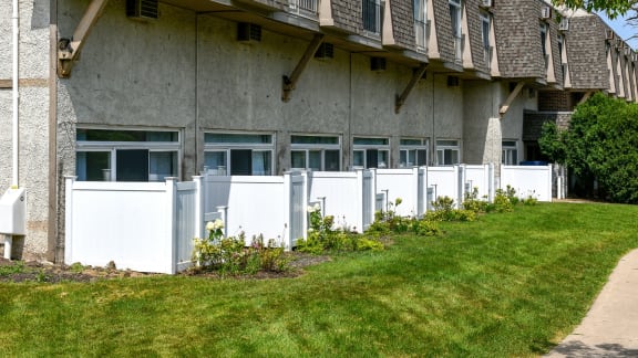 Ground level patios with white privacy fencing at Fox Run Apartments, St. Charles, Illinois
