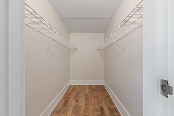 Walk-in closet with wire shelving on both sides at Fox Run Apartments, Illinois
