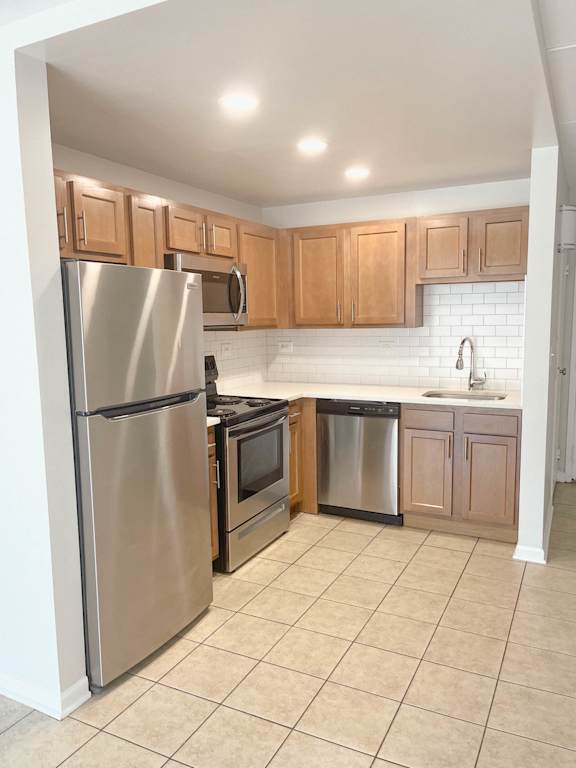 Floor Plan  Compact kitchen with light wood cabinets and tile floor at Fox Run Apartments, Illinois