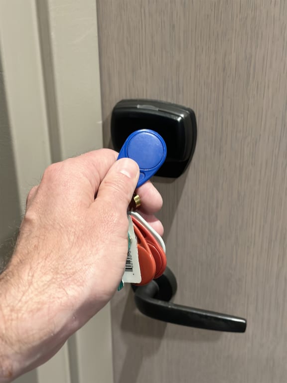 a hand is holding a key in a door handle