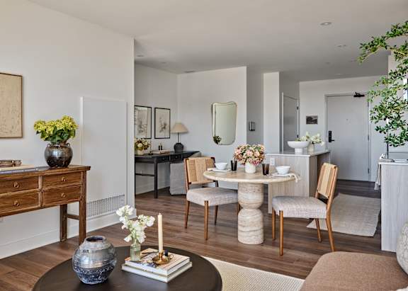 A dining room with a round table and chairs.