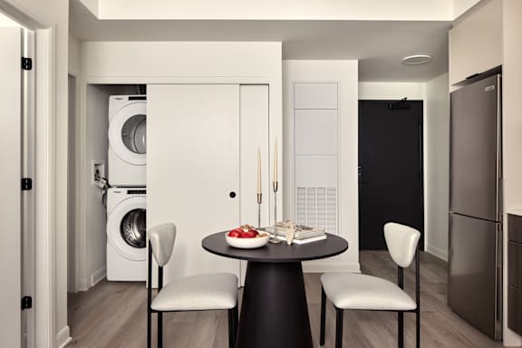 A modern kitchen with a table set for two.