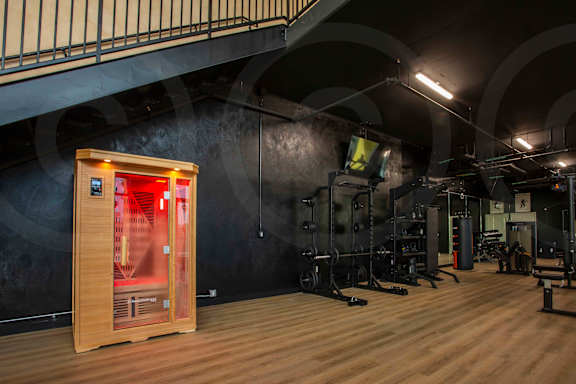 A gym with a sauna and exercise equipment.