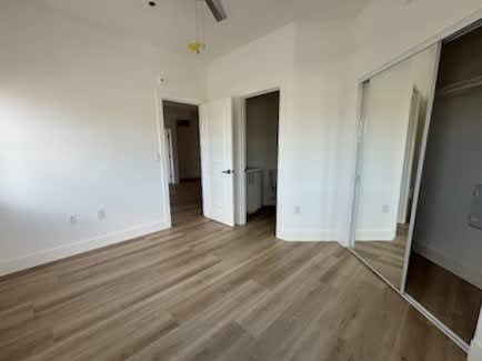 A room with wooden floors and white walls.