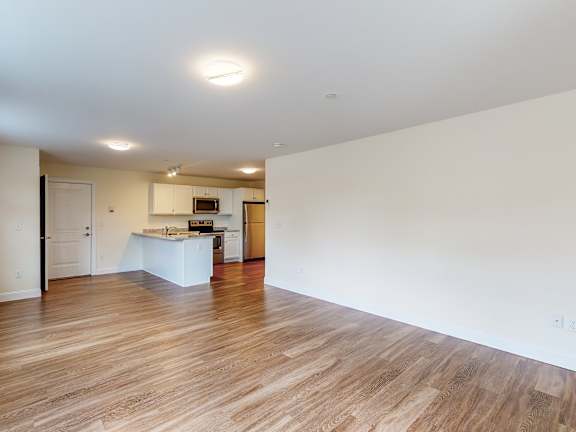 Open floor plan with kitchen and hardwood floors at Autumn Woods Apartments, Westbrook