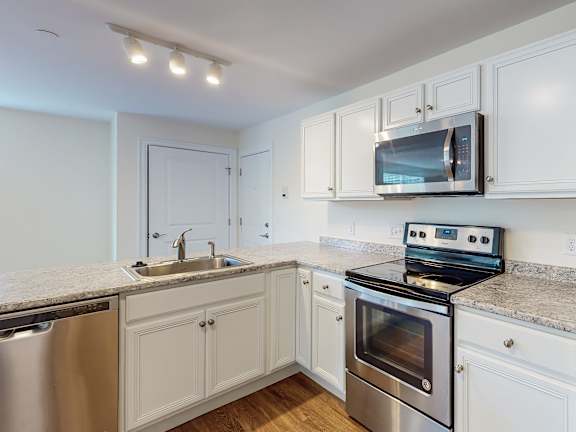 Kitchen with stainless range and microwave hood at Autumn Woods Apartments, Westbrook