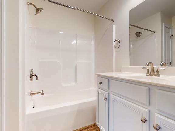 Bathroom with tub shower combo and vanity at Autumn Woods Apartments, Westbrook, ME