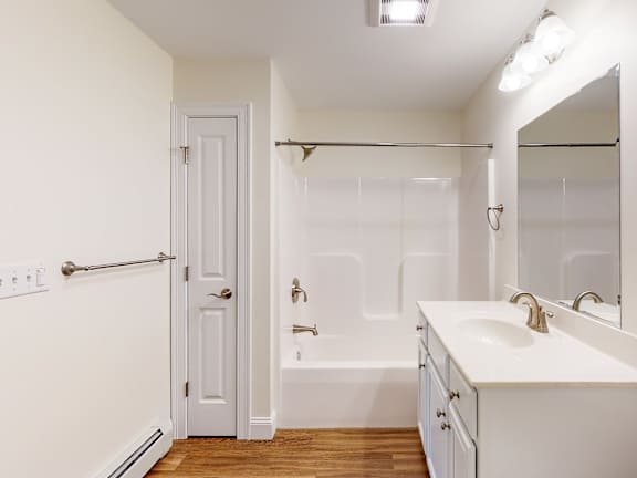 Bathroom with built in tub and white vanity at Autumn Woods Apartments, Westbrook, 04092