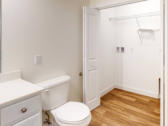 Bathroom with toilet and walk-in closet access at Autumn Woods Apartments, Westbrook