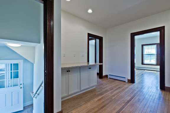 A room with wooden floors and white walls.