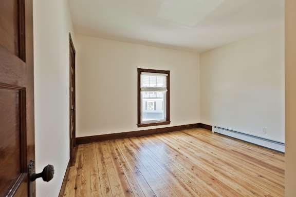 A room with wooden floors and a window.