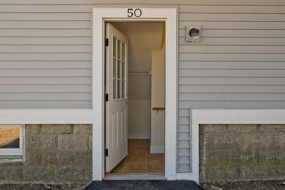 A white door with the number 50 on it is open.