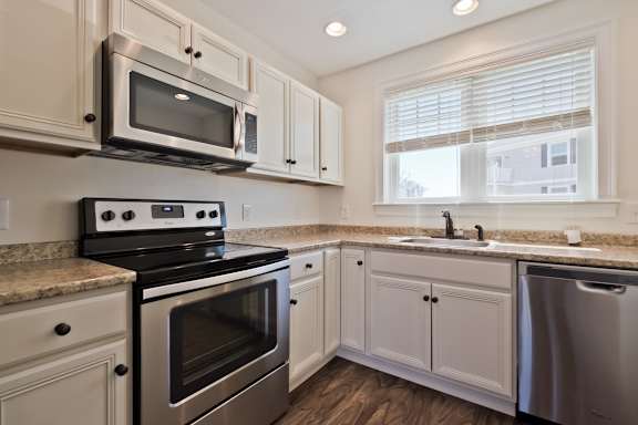 A kitchen with a stove, microwave, and dishwasher.