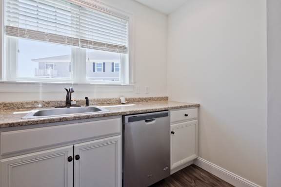 A kitchen with a sink and a dishwasher.