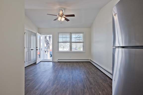 A room with a ceiling fan and a window.