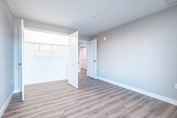 Empty bedroom with walk-in closet and open door at Windham Village Apartments, Windham, Maine