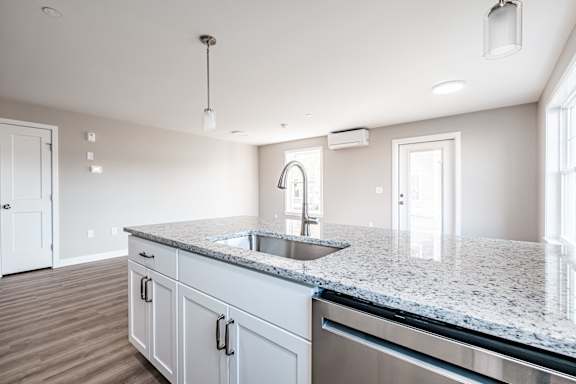 Kitchen island with sink and granite countertop at Windham Village Apartments, Windham, ME 04062