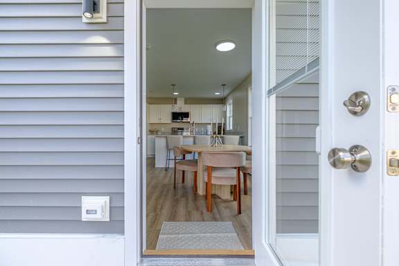 Open front door leading into modern kitchen at Windham Village Apartments, Windham, 04062