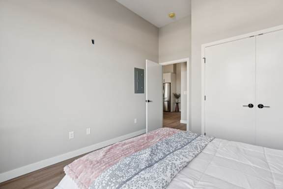 A bedroom with a bed in the foreground and a closet with a door numbered 1 on it.