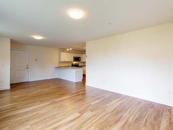 Spacious open living area with kitchen bar at Autumn Woods Apartments, Westbrook