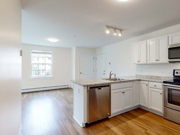 Kitchen island with dishwasher and open floor plan at Autumn Woods Apartments, Westbrook, ME 04092