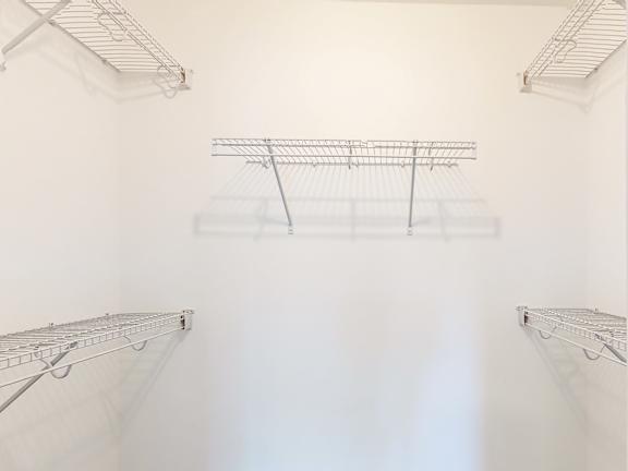 Walk-in closet with wire shelving systems at Autumn Woods Apartments, Westbrook, Maine