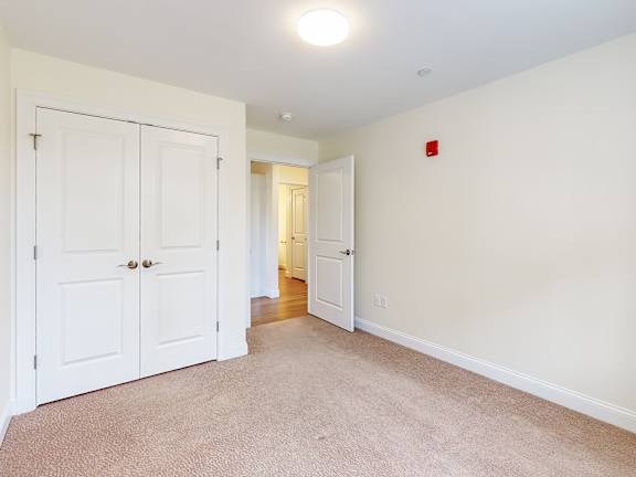 Empty carpeted room at Autumn Woods Apartments, Westbrook, 04092