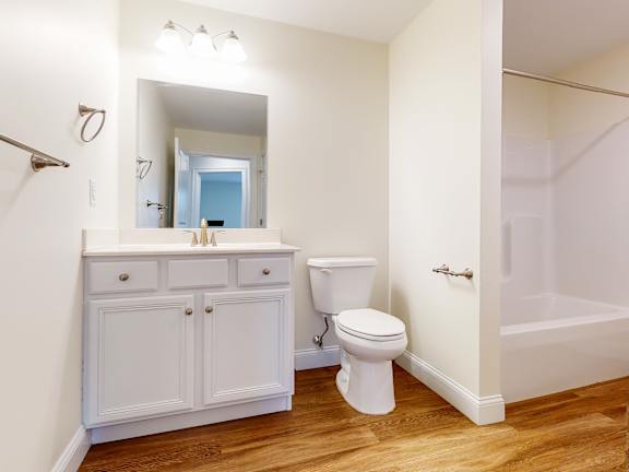 Bathroom with white vanity and wood flooring at Autumn Woods Apartments, Westbrook