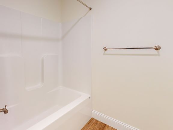 Bathroom with tub shower combo and grab bar at Autumn Woods Apartments, Westbrook, ME 04092