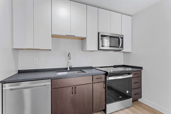 a kitchen with white cabinets and stainless steel appliances