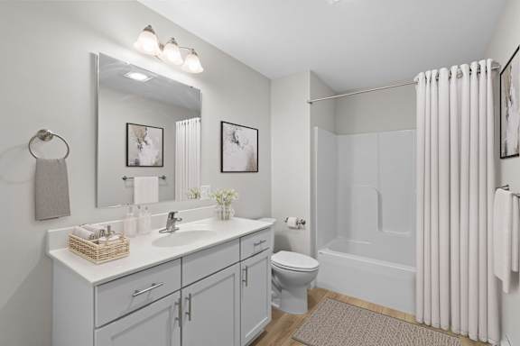 A bathroom with a white sink, toilet, and bathtub.