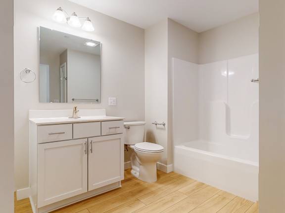 A white bathroom with a sink, toilet, and bathtub.