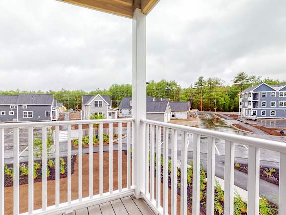 A view from a balcony overlooking a residential area.