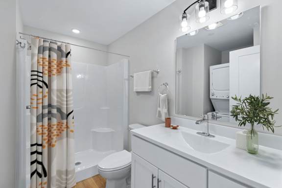 A Modern Bathroom with the Convenience of an In-Unit Washer and Dryer