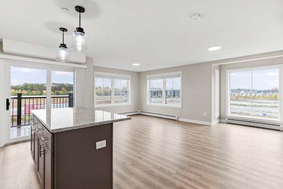 A spacious kitchen with a view of the outdoors through large windows.